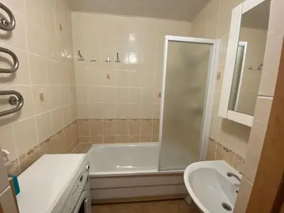 a bathroom with a shower and a tub and a sink at Butas Senamiestyje in Druskininkai