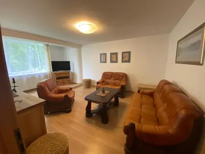 a living room with a couch and chairs and a table at Butas Senamiestyje in Druskininkai