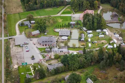 an aerial view of a house with a parking lot at Meškių dvarkiemis in Šiauliai