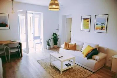 a living room with a couch and a table at Modern Apartment Next to Kaunas Castle in Kaunas