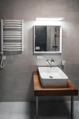 a bathroom with a sink and a mirror at Modern Apartment Next to Kaunas Castle in Kaunas