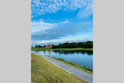 a view of a river with a blue sky at Modern Apartment Next to Kaunas Castle in Kaunas