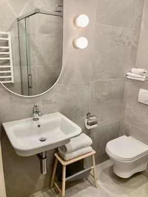 a bathroom with a sink and a toilet and a mirror at COME2rest - Subaciaus 5 in Vilnius