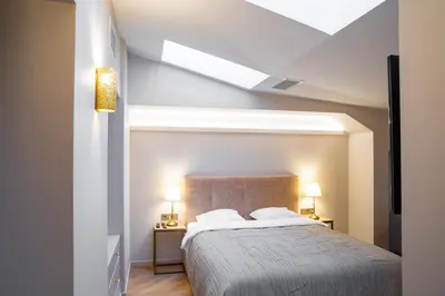 a bedroom with a bed and two night stands with lamps at COME2rest - Subaciaus 5 in Vilnius