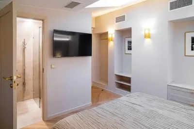 a bedroom with a bed and a flat screen tv at COME2rest - Subaciaus 5 in Vilnius
