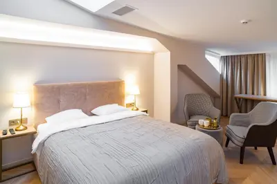 a hotel room with a bed and a chair at COME2rest - Subaciaus 5 in Vilnius