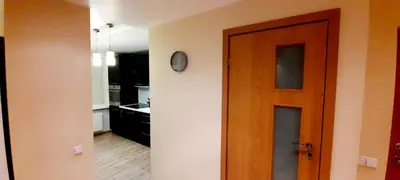 a hallway with a door and a kitchen at M&M Apartment VIII Self CHECK-IN in Panevėžys