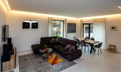 a living room with a couch and a table at Pine Home in Druskininkai