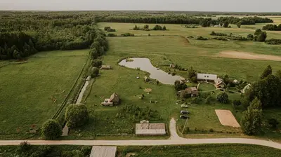 an aerial view of a farm with animals in a field at Vienkiemio Oazė - Namelis Prie Šermukšnio in Galvokai
