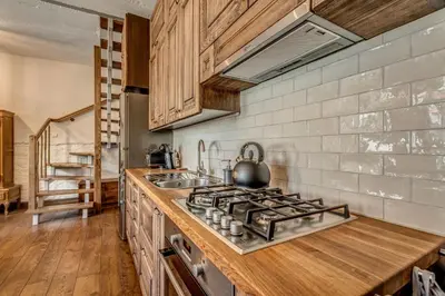 a kitchen with a stove top oven next to a sink at House of Nobles with personal terrace in Užupis in Vilnius