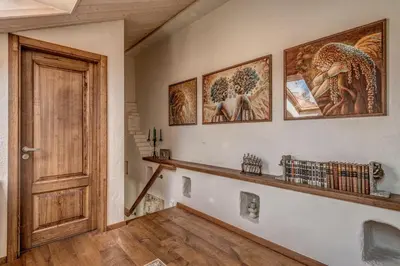 a hallway with a door and some pictures on the wall at House of Nobles with personal terrace in Užupis in Vilnius