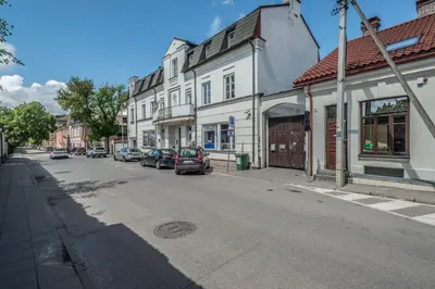 a city street with cars parked on the street at House of Nobles with personal terrace in Užupis in Vilnius