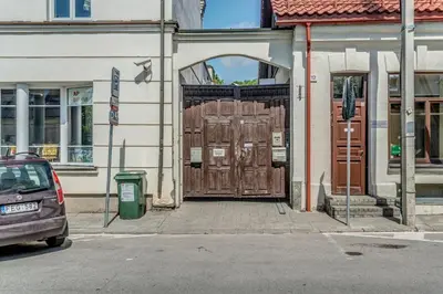 a car parked in front of a building with wooden doors at House of Nobles with personal terrace in Užupis in Vilnius