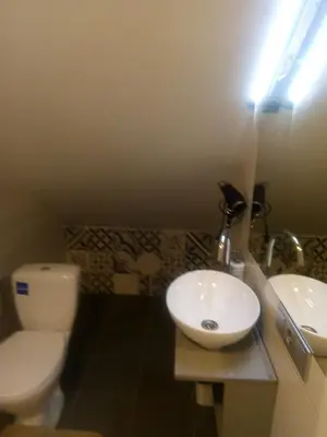 a bathroom with a white toilet and a sink at Attic rooms at Laisves avenue in Kaunas