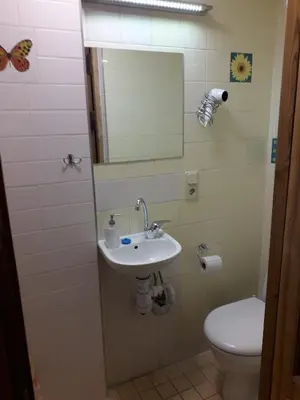 a bathroom with a sink and a toilet at Attic rooms at Laisves avenue in Kaunas