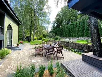 a patio with a table and chairs in a garden at 