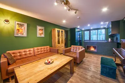 a living room with a couch and a table and a fireplace at 
