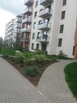 a brick walkway in front of a building at Near PANORAMA apartment Self check-in Garage free in Vilnius