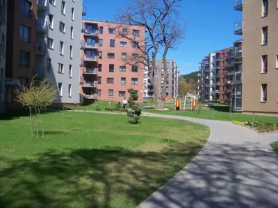 a park in a city with tall buildings at Near PANORAMA apartment Self check-in Garage free in Vilnius