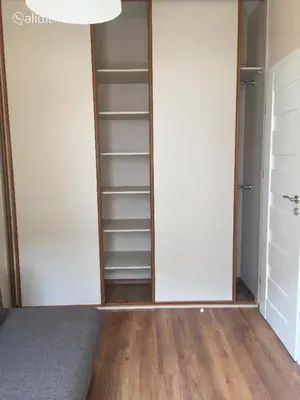 an empty closet with white walls and wooden floors at Near PANORAMA apartment Self check-in Garage free in Vilnius
