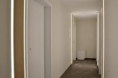 an empty hallway with white walls and a white door at Tip Tap Guest House in Druskininkai
