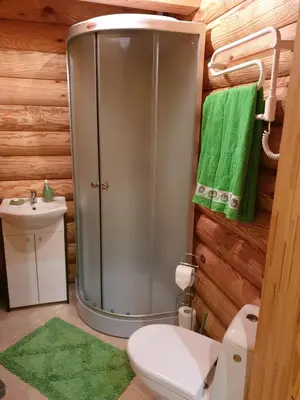 a bathroom with a shower with a toilet and a sink at Pušų Šlamesy in Vilnius