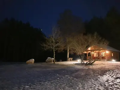 a cabin in the snow at night at Pušų Šlamesy in Vilnius
