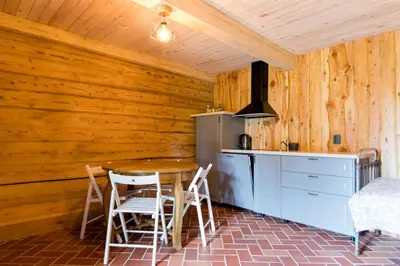 a kitchen with a table and chairs in a room at ETNO house in Ricieliai