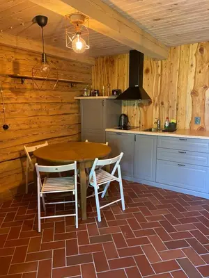 a kitchen with a table and chairs in a room at ETNO house in Ricieliai