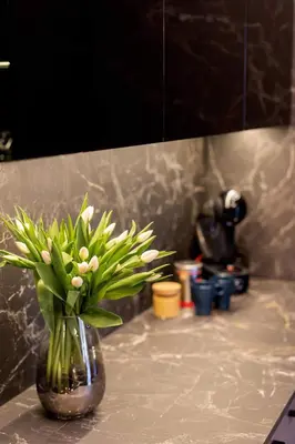 a vase filled with white flowers on a counter at Stay in Kaunas & Park House in Kaunas