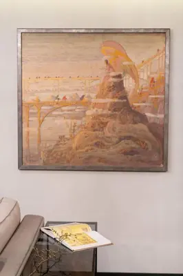 a painting hanging on a wall next to a table at Stay in Kaunas & Park House in Kaunas