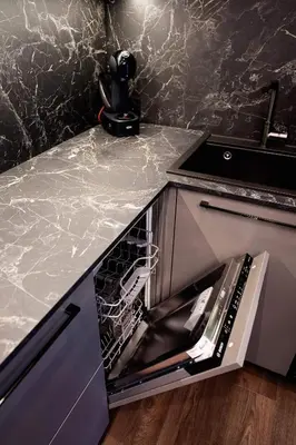 a kitchen counter with an empty dishwasher in a sink at Stay in Kaunas & Park House in Kaunas