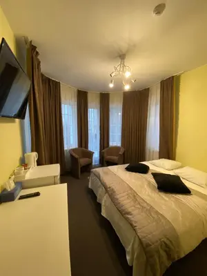 a hotel room with a large bed in a room at La-Vanda in Šiauliai