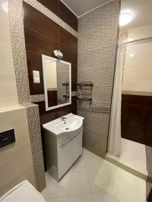 a bathroom with a sink and a shower and a toilet at La-Vanda in Šiauliai