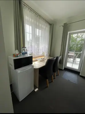 a room with a table and chairs and a window at La-Vanda in Šiauliai