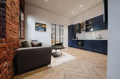 a living room with a couch and a brick wall at Modern apartment in Kaunas city center in Kaunas