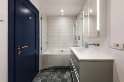 a bathroom with a blue door and a tub and a sink at Modern apartment in Kaunas city center in Kaunas