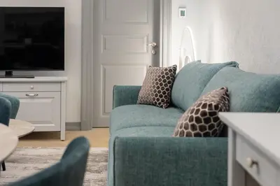 a living room with a blue couch and a tv at #stayhere - Modern Luxury Apartments in the Heart of Old Town Vilnius in Vilnius