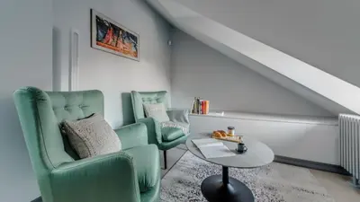 a living room with two chairs and a table at #stayhere - Modern Luxury Apartments in the Heart of Old Town Vilnius in Vilnius