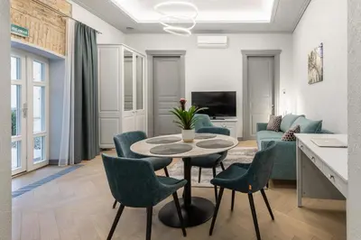 a living room with a table and chairs at #stayhere - Modern Luxury Apartments in the Heart of Old Town Vilnius in Vilnius