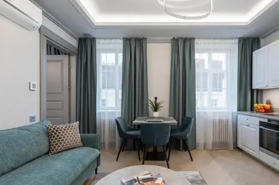 a living room with a couch and a table with chairs at #stayhere - Modern Luxury Apartments in the Heart of Old Town Vilnius in Vilnius