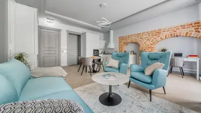 a living room with a blue couch and chairs at #stayhere - Modern Luxury Apartments in the Heart of Old Town Vilnius in Vilnius