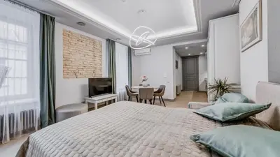 a bedroom with a large bed and a dining room at #stayhere - Modern Luxury Apartments in the Heart of Old Town Vilnius in Vilnius