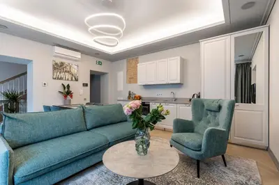 a living room with a couch and two chairs and a table at #stayhere - Modern Luxury Apartments in the Heart of Old Town Vilnius in Vilnius