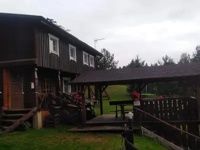 a house with a picnic table in front of it at Kaimo turizmo sodyba Stromelė in Baltriškės