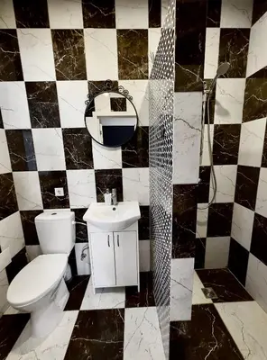 a bathroom with a toilet and a sink at Very Bad Hootel in Kaunas