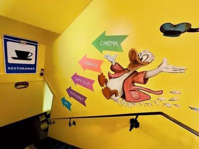 a wall with a painting of a mouse on it at Very Bad Hootel in Kaunas
