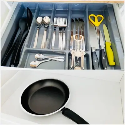 a drawer filled with utensils and a frying pan at M&M Apartment VII Self CHECK-IN in Panevėžys
