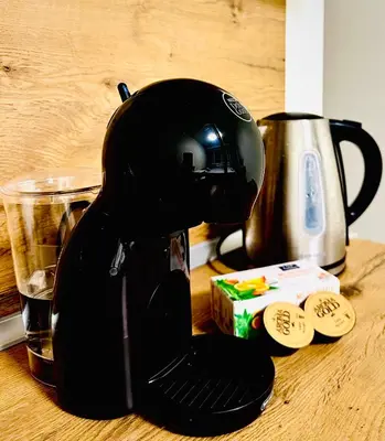 a coffee maker sitting on a table next to a coffee pot at M&M Apartment VII Self CHECK-IN in Panevėžys