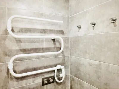 a walk in shower with two hand rails in a bathroom at M&M Apartment VII Self CHECK-IN in Panevėžys
